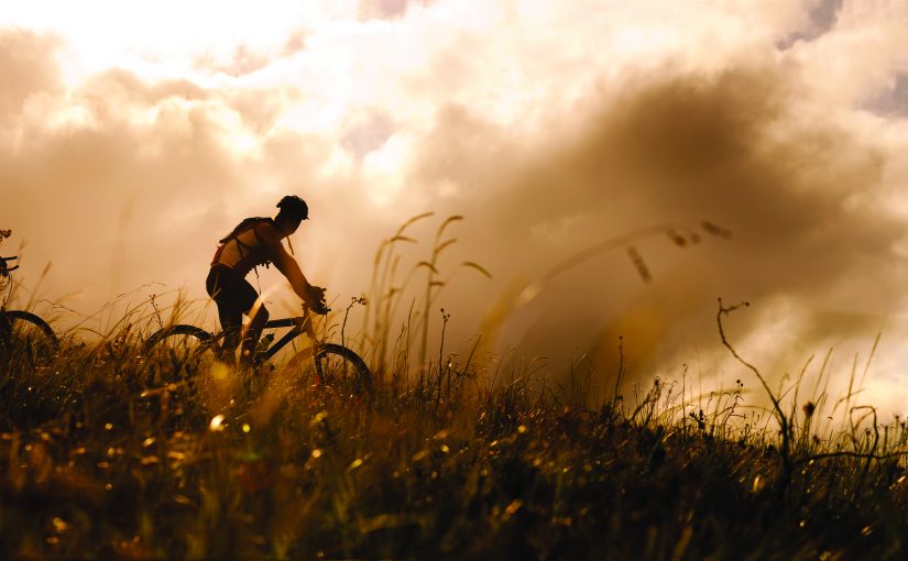 Happy couple riding bicycles outside, healthy lifestyle fun concept