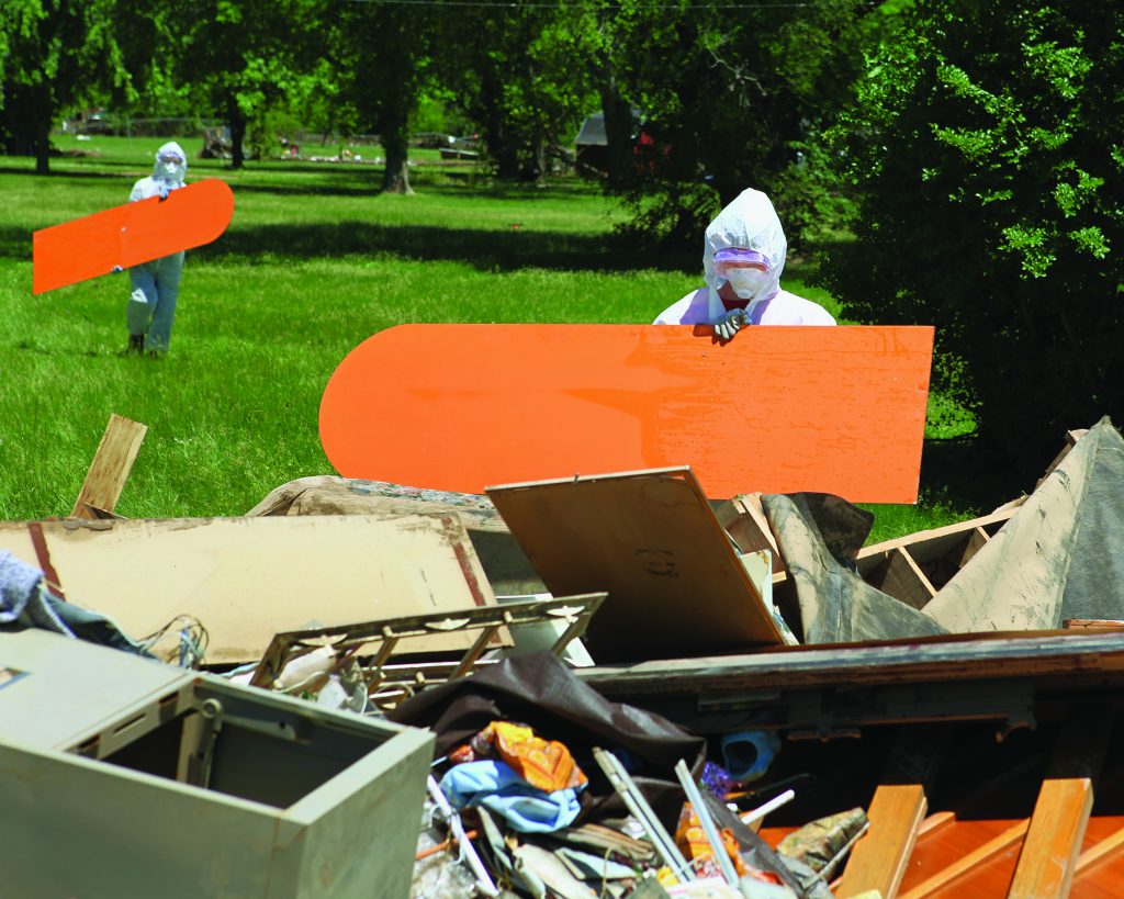 Emergency workers cleaning up site of destroyed building