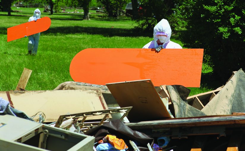 Emergency workers cleaning up site of destroyed building