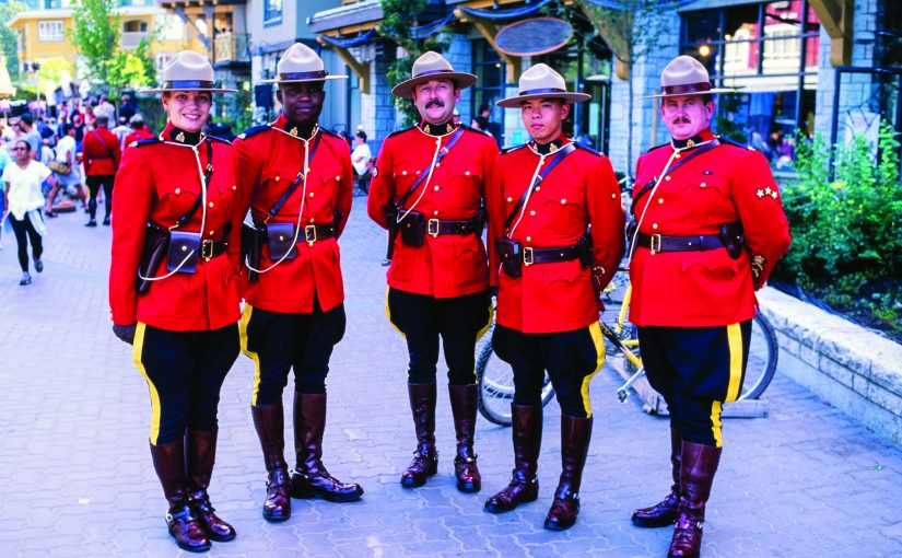 These officers in the Red Serge traditional uniform are posing during the Canada day celebration held in the ski resort of Whistler, 120km North of Vancouver Canada.