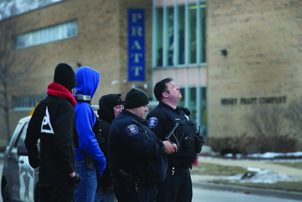 Police secure the area following a shooting at the Henry Pratt Company, February 15, 2019.