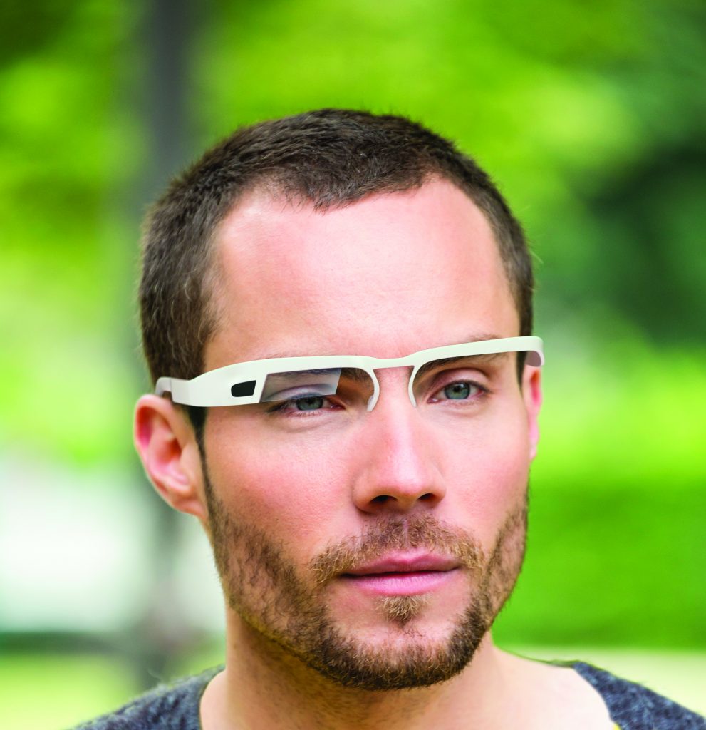 Young man with wearable computer in form of smart glasses.