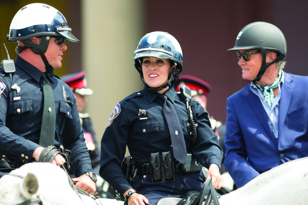 Indianapolis, Indiana, USA - May 26, 2018, Police officers on horses going down the street at the Indy 500 Parade