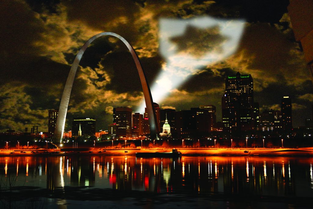 Night shot of St. Louis projecting badge symbol as a call for help