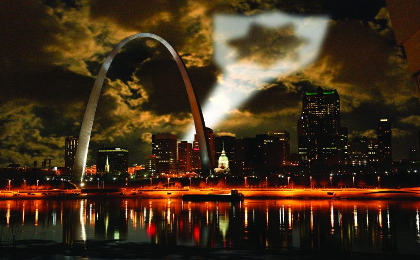 Night shot of St. Louis projecting badge symbol as a call for help