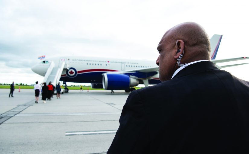 A member of the RCMP’s Protective Services surveils the tarmac as the Government of Canada plane arrives at the Canada Reception Centre at the Ottawa Macdonald-Cartier International Airport in May 2022.