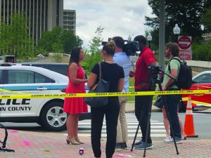 Ashley Savage, Public Information Officer, Arlington County Police Department, giving an interview at a crime scene.